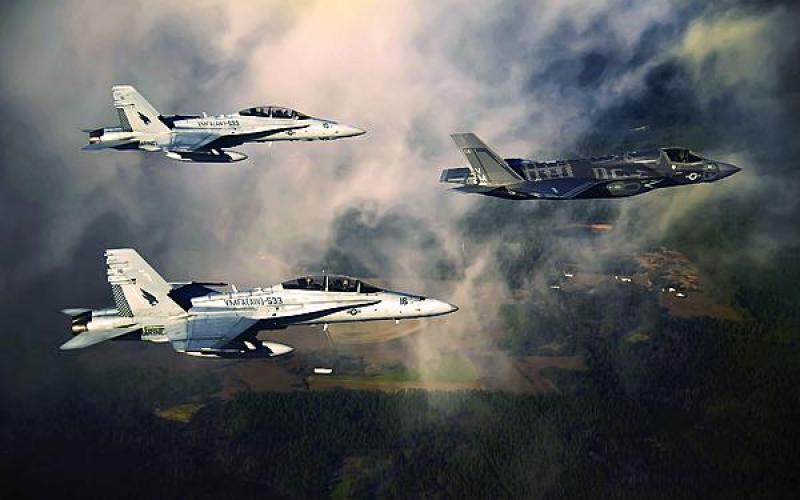 A U.S. Marine Corps F-35 aircraft is escorted by two Marine F/A-18 Hornets as it flies toward Eglin Air Force Base, Florida. Later this year, the Defense Department will establish a program of record to ensure communications between different generations of fighter aircraft, and that program will feed into the Joint Aerial Layer Network vision.