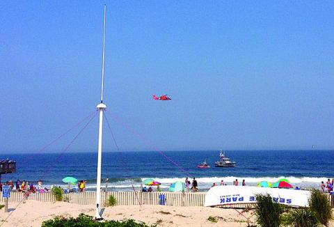 As Coast Guard vessels and a helicopter patrol the waters off a beach in New Jersey, a CODAR SeaSonde HF radar scans the ocean to provide vital sea state information to NOAA. 