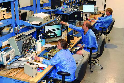 Technicians at Tobyhanna Army Depot work on communications-electronics systems in the Depot Maintenance of the Future (DMOF) facility. The 10,000-square-foot center, which serves as a working laboratory for new technology and processes, is designed to stimulate new ideas and work techniques. 