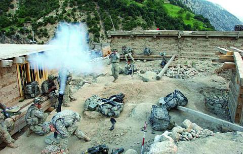 U.S. Army soldiers from the 10th Mountain Division’s 3rd Brigade Combat Team fire mortars at the fighting positions of opposing forces during a combat operation in the village of Barge Matal in the eastern Nuristan province of Afghanistan in 2009. New technologies will give the unit unprecedented combat communications capabilities for its next deployment to Afghanistan, Army officials say.