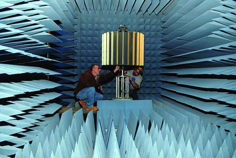 Two Tobyhanna Army Depot electronics experts set up a lightweight counter mortar radar system for rotation testing in an anechoic test chamber. This test removes the need for actual live-fire exercises and saves the Army tens of thousands of dollars for each system deployed to the field.