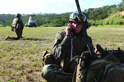 A radio operator for Combat Logistics Battalion-31, 31st Expeditionary Unit (MEU) communicates with the command element during a mass casualty evacuation exercise in Japan.