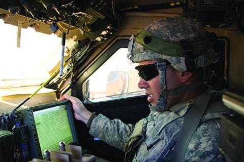 A U.S. Army soldier communicates inside his vehicle during the Army's Network Integration Evaluation (NIE) 12.2 in spring 2012. 
