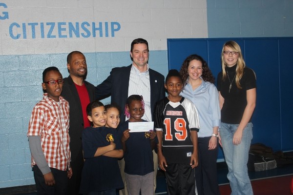 Tim Wills (back l) gathers with Tim Jahnigan, vice president of Young AFCEANs; Christa Dahlem (2nd from r), 5K Planning Committee member; Stacy Kauffman, 5K Planning Committee member; and appreciative boys and girls of Harford County for a check presentation of $3,500 from the chapter in February. 