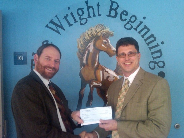 Russ Kovach (l) of C. Milton Wright High School receives a Science Teacher Toolkit Award in December from Jeff Murter, chapter vice president of education.