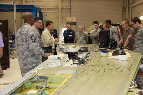Jon Cutshall (3rd from l), principal engineer in the aerospace structures section at the Southwest Research Institute, shows visitors from the chapter where stress gauges will be attached to the wing of a T-38 aircraft. The group's visit in January was part of the chapter's Industry Tours initiative, which helps to build connections between military personnel and industry partners.