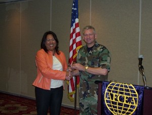 Nancy Kudla, chapter vice president, presents a token of appreciation to Col. Kross, 26th Network Operations Group, for his March presentation.