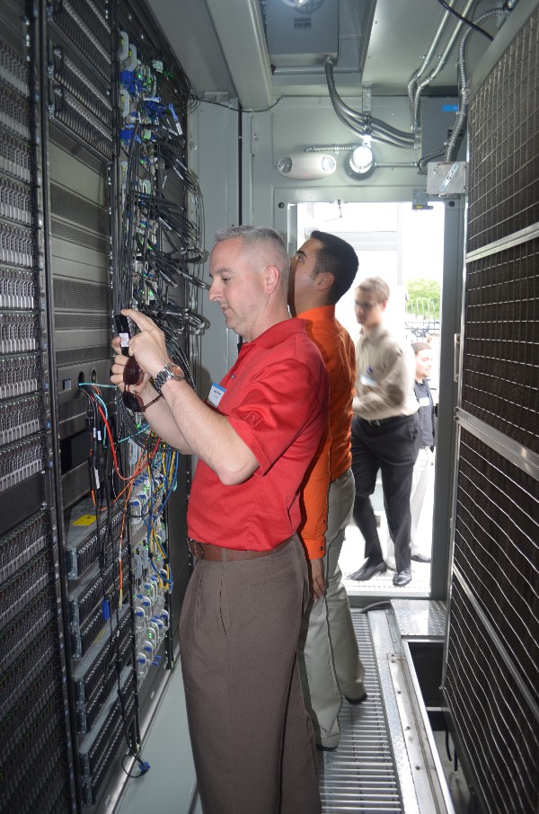 Young AFCEAN Kelly Bales gets a close-up look at Dell Computer Corporation's Modular Data Center, which features several petabytes worth of data storage, during an Industry Tour in April. The data storage was jaw dropping for many, who said they have never seen anything close to housing a petabyte before.
