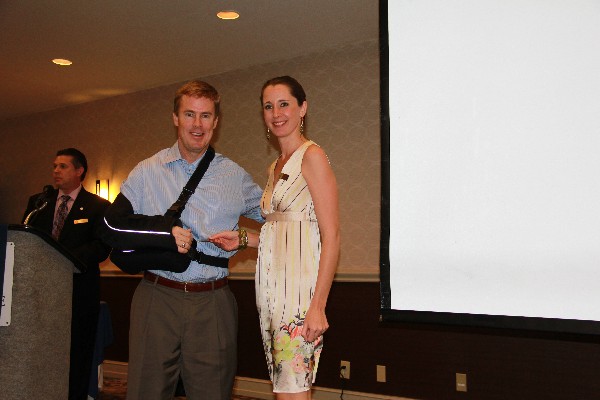 Emily Rausch, local vice president for Young AFCEANs, accepts a token on behalf of corporate sponsor K2Share from Bill Morrow, chapter president, in February.