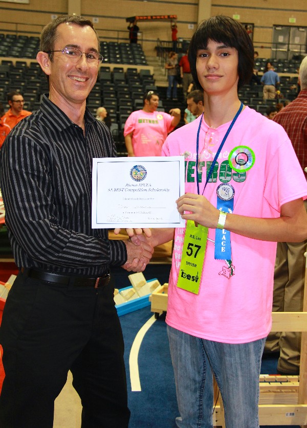 Clay Perce (l), the chapter's vice president of scholarships and educational grants, awards a $2,000 scholarship to Daniel Joaquin of Robert E. Lee High School, which took first place in the robotics competition portion of the state-qualifying round in November.
