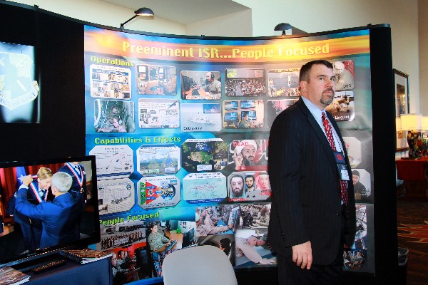 Todd Wilson mans the exhibit booth for the Air Force Intelligence, Surveillance and Reconnaissance Agency (AFISRA) during the December conference. The exhibit was a virtual exploration of the ISR mission, showing quiet intelligence gathering and targeting