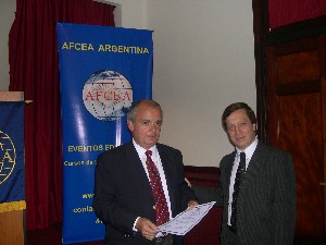 Robert Mayer (r), chapter member, presents a certificate of appreciation to Alejandro Fargosi, a legal consultant, who spoke about the new law on audiovisual media services at the chapter's October event.