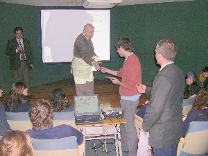 Maj. Gen Francisco E. Machinandiarena, ARA (Ret.), chapter president, gives away MP3 players to students after the Opening Minds to Technologies program in June.