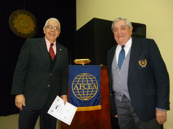 Professor Roberto Uzal, director of the Ph.D. in computer engineering at the National University of San Luis (l) receives a certificate of recognition from Rear Adm. Emilio Nigoul, ARA (Ret.), chapter president, in May.