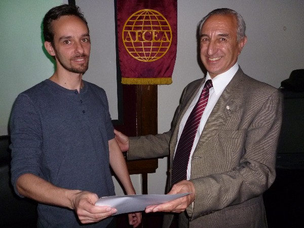 In November, Monticeli (l) receives a certificate of recognition from Luis Favotto, chapter board member and coordinator. 