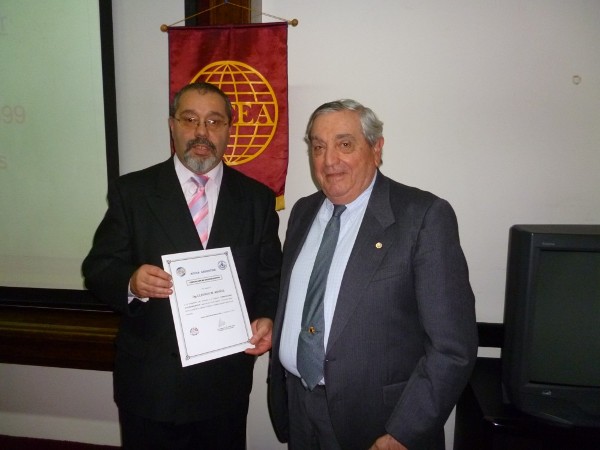 Rear Adm. Emilio I. Nigoul, ARA (Ret.) (r), chapter president, gives a certificate of recognition to Muoz in August.