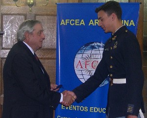 Emilio I. Nigoul (l), chapter first vice president, presents a medal to science fair winner Cadet Rodriguez Aro in October.