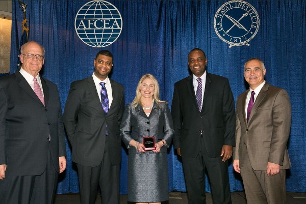 Kent Schneider (l), president and chief executive officer of AFCEA International, and Al Grasso (r), chair of AFCEAs board, join chapter leaders to present the Distinguished Young AFCEAN Award to Ashley Becker in January.