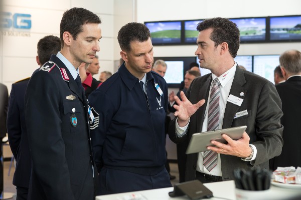 Young AFCEANs Maj. Lars Bibow, GEAF (l), Master Sgt. Todd Weingeroff, USAF, and Jochen Reinhardt, BWI Informationstechnik, discuss information technology trends at this year's Bonn TechExpo in May.