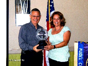 Kent Angell, director, Eco Datacenter Practice, Sun Microsystems, accepts an AFCEA clock from Heidi Hughes, chapter president, as a token of appreciation for his presentation at the July meeting.