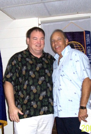 Col. Ramos (r) congratulates Glenn Exline, incoming chapter president, at the October meeting.