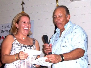 In October, Heidi Hughes, chapter director and outgoing chapter president, accepts a donation from Col. Ramos. The funds will go toward the chapter's scholarship program.