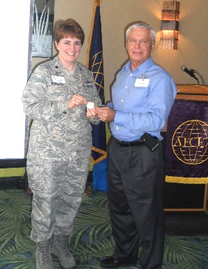 Lt. Col. Pamela Woolley, USAF, chapter vice president and commander of the 45th Space Communications Squadron, receives a token of appreciation from Lou Linden, chapter president, at the November meeting.
