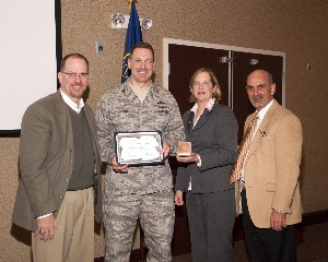 Joining together at the January meeting are (l-r) David Judson, past chapter president; Col. Rob Lyman, USAF, commander, 88th Communications Group, Wright-Patterson Air Force Base; Jackie Whitaker, immediate past chapter president; and Dan Curtis, chapter president.