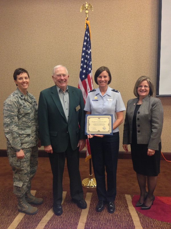 Lt. Col. Brenda Oppel, USAF, chapter vice president of programs (far l); Regional Vice President Fred Scheyd (second from l), and Chapter President Linda Skinner (r) present a chapter coin and certificate to Brig. Gen. Sarah E. Zabel, USAF, director, cyberspace strategy and policy, Office of Information Dominance and chief information officer, Office of the Secretary of the Air Force, at the August luncheon.