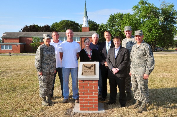 At the opening ceremony for a memorial tribute to fallen heroes in July are (l-r) Col. Amanda Gladney, USAF; Brad Zirkle; Joshua Hale; Jo Lynn Anderson; Bert Crain; Casey Weinstein; Aaron Miller; Col. Rob Lyman, USAF; and Chief Master Sgt. John Mazza, USAF. 
