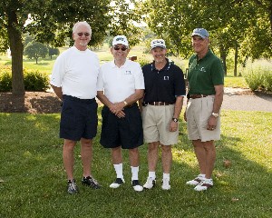 The Greentree Group takes a swing at the first tee during the chapter's Spring Scholarship Golf Tournament in July.