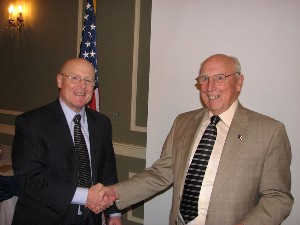Dennis O'Connell (l), chapter vice president, shakes hands with Alfred A. Buckles, vice president, Science Application International Corporation (SAIC) account manager, U.S. Strategic Command, following his speak at the December luncheon.