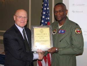 At the December luncheon, O'Connell (l) presents a lifetime membership certificate to Lt. Col. Montague D. Samuel, USAF, professor of aerospace studies and commander of Air Force ROTC Detachment 280 at the University of Kansas.