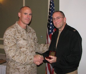 In November, Col. Kirk Bruno, USMC (l), chapter president, presents a token of appreciation to Capt. David Coughlin, USN, knowledge manager, C4 Systems Directorate, U.S. Strategic Command.