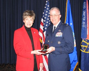 Dr. Winnie L. Callahan, Peter Kiewit Institute and University of Nebraska Foundation, receives a memento of appreciation from Col. Christopher L. Moore, USAF, chapter vice president, for her April presentation.