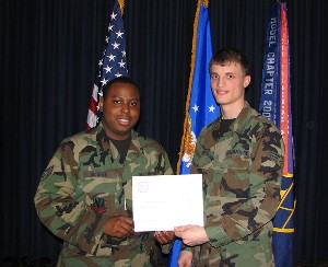 Senior Airman William A. McGee, USAF (l), chapter Lead Young AFCEAN, presents a certificate in April to computer science major Senior Airman Gene O. Pabst, USAF, recipient of the chapter's $1,000 Dawn Meyerriecks Book and Fee award.