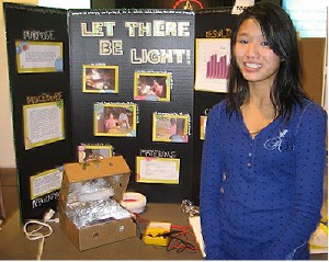 In honor of Women's History Month in March, chapter science fair project junior category winner Shannon Cooney, an eighth-grade student at Trinity Christian School, Omaha, displays her project, "Let There Be Light," which tested the effectiveness of light sources and colors on power generation of solar cells. Cooney received $100 for her project submission.