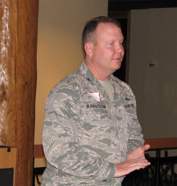 Col. Eric Bjurstrom, USAF, chapter president and commander, Defense Information Systems Agency Field Office at the U.S. Strategic Command, Offutt Air Force Base, Nebraska, provides welcoming remarks for the chapter's 2nd Holiday Mixer, an event held in December to give back to program sponsors and the membership.