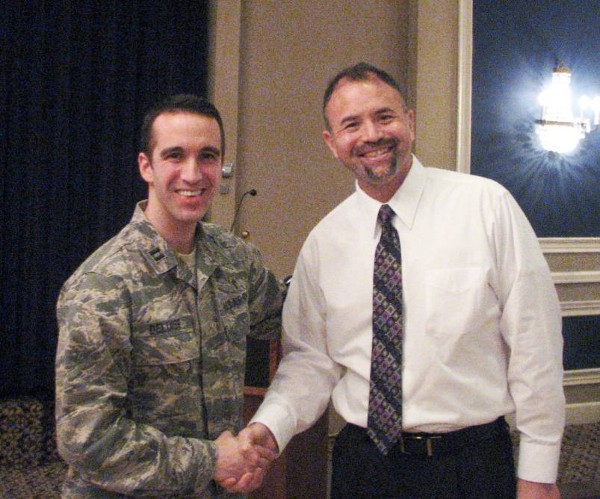 Capt. Christopher DeLuise, USAF (l), Mission Support Group chaplain, 55th Wing, Offutt Air Force Base, shakes hands with William Cowgill, chapter diversity liaison. Capt. DeLuise received a chapter coin for his diversity presentation to the chapter on cultural differences in January.