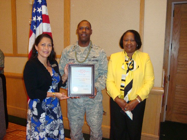 In January, Pacheco (l) recognizes Col. Hatcher, who is joined by Dorothy Hatcher.
