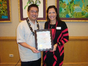 In January, Pacheco (r) presents the Executive of the Month Award to Schaefer.