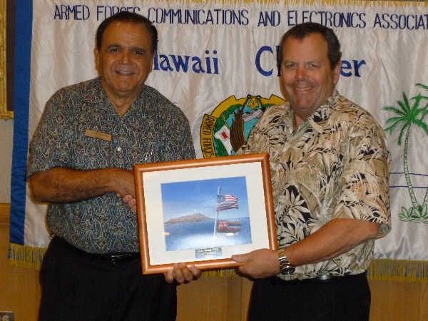 In November, Lindo (l) recognizes Larry Osborne, senior vice president and chief operating officer, Dreamhammer, for his work as the chapter’s vice president of publicity in 2011.