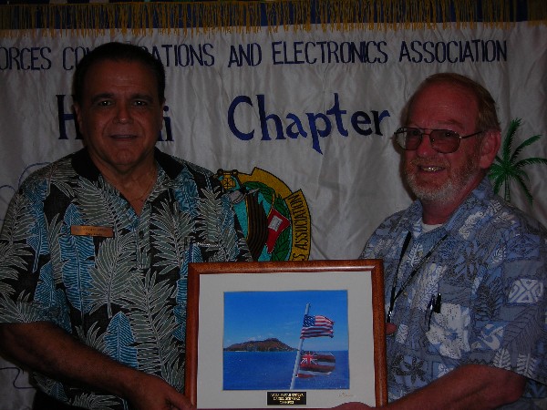 Daniel Schwarz (r), CACI International, receives a token of appreciation in January from Lindo recognizing his work as chapter vice president of finance from 2008-2012.
