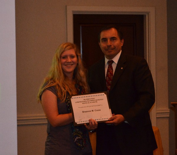 Shaw congratulates Breanna Crane on her chapter scholarship award at the August luncheon.