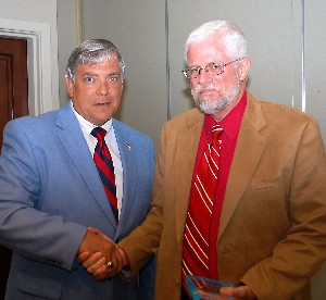 Vic Budura (l), chapter president, presents David Weeks, COLSA Corporation, with a special token of appreciation. Weeks served as the guest speaker in June.