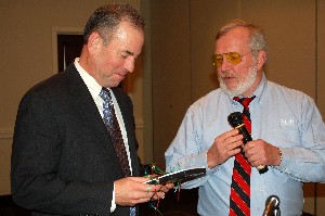 W. Douglas Scalf (l) receives the door prize from January guest speaker Bill Waite, co-founder, chairman and chief technology officer of the AEgis Technologies Group.