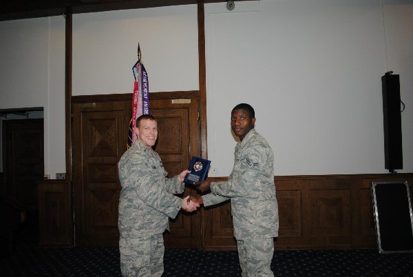 2nd Lt. Jason Loomis, USAF (l), presents the Emerging Leader Award to Airman 1st Class Michael Pirtle, USAF, during the March luncheon.