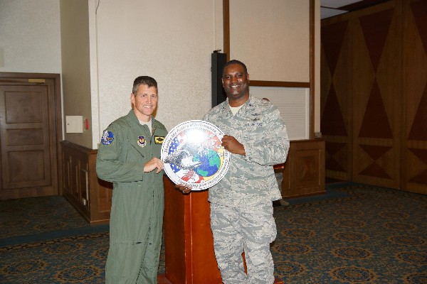 Col. Chris Brooks, USAF (r), chapter vice president, presents Col. Franz M. Plescha, USAF, commander, Warrior Preparation Center, with a chapter coin as thanks for his speech during the October membership luncheon.