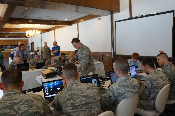 1st Lt. Robert M. Lee, USAF, gives instructions to hackINT students during the summer technology expo in July.