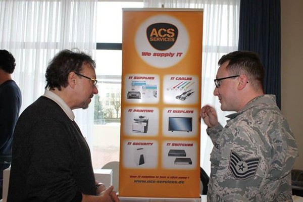 A local vendor provides product and services information to a Kaiserslautern Winter Tech Expo visitor in February.  